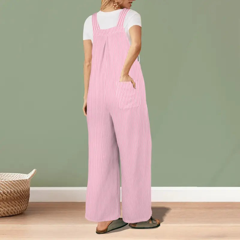 Girl rocking a pink striped jumpsuit over a white t-shirt for a comfy look