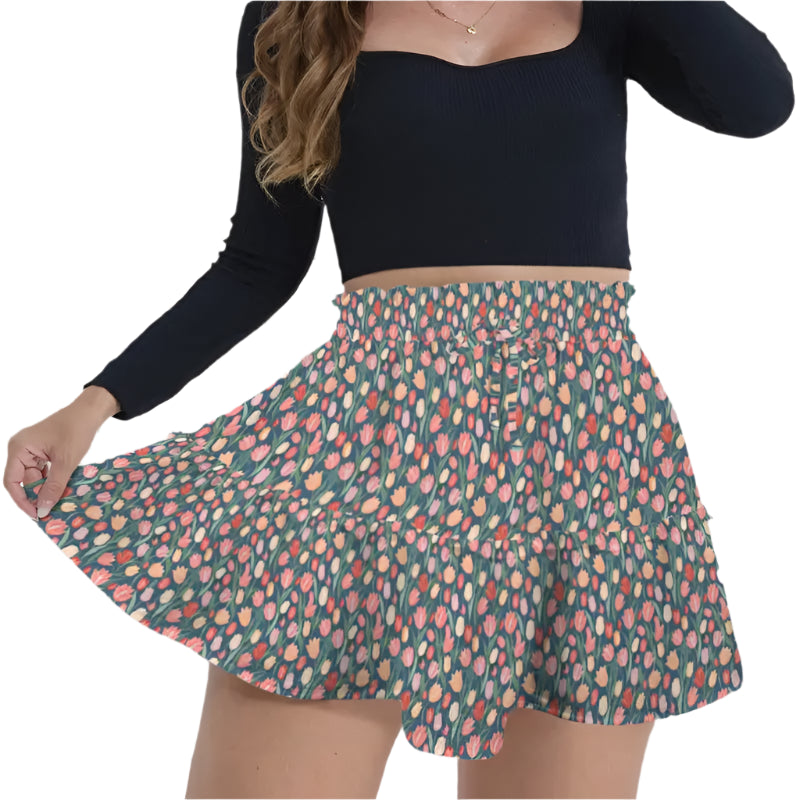 Floral print pleated mini skirt featuring high waist design on a green background