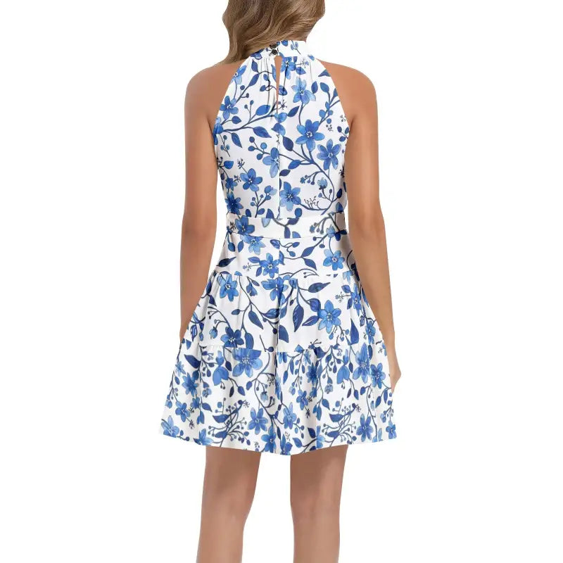 Sleeveless white dress featuring a blue floral print and halter neckline, perfect floral belted halter dress