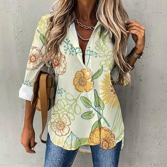 Floral print blouse featuring vibrant yellow and green flowers on a light background