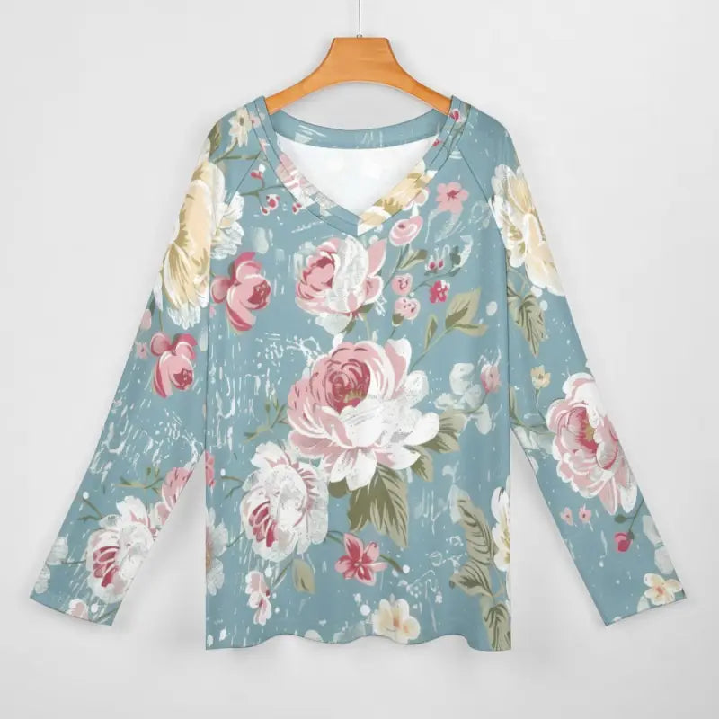 Soft blue long-sleeved t-shirt with v-neck design and pink floral pattern