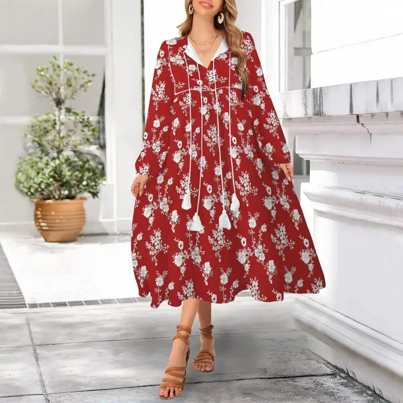 Red floral flowy maxi dress with long sleeves and tassel ties for a chic look