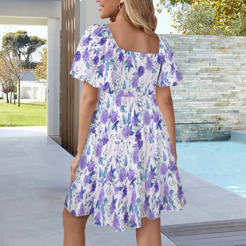 Flowy violet tiered dress with purple and blue floral print and short puff sleeves