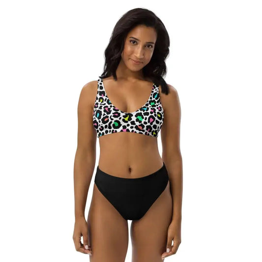 Woman flaunting a colorful leopard print bikini top and chic black high-waisted bottom