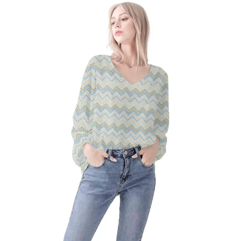 Woman rocking a chevron-patterned blouse and blue jeans for that ultimate boho long sleeve vibe