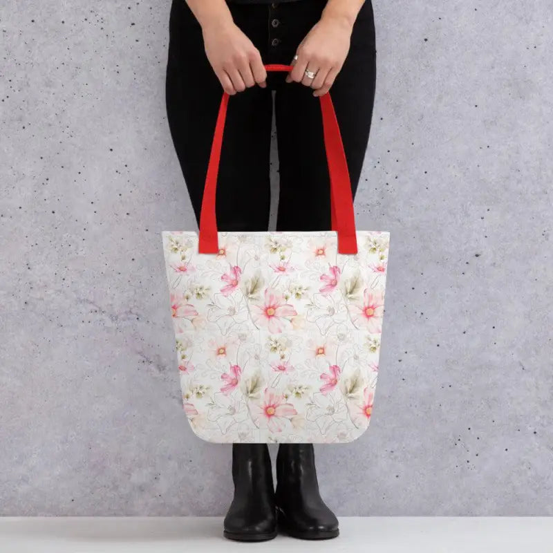 Wildflower Floral Tote with red handles held by a person in black clothing