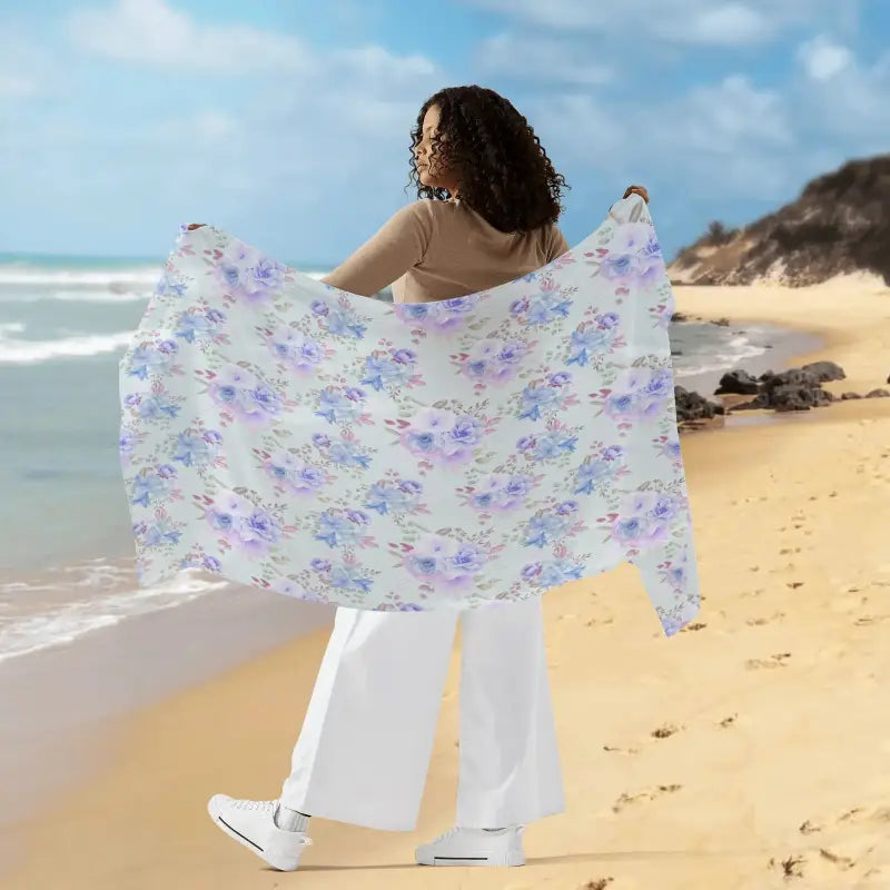 Womens Blue Pattern Sarong held on the beach, showcasing a vibrant floral design