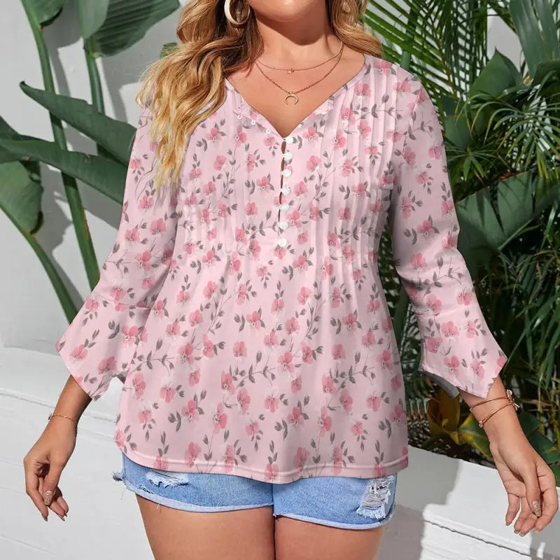 Women’s pink floral print bohemian top featuring a v-neck and cute button details