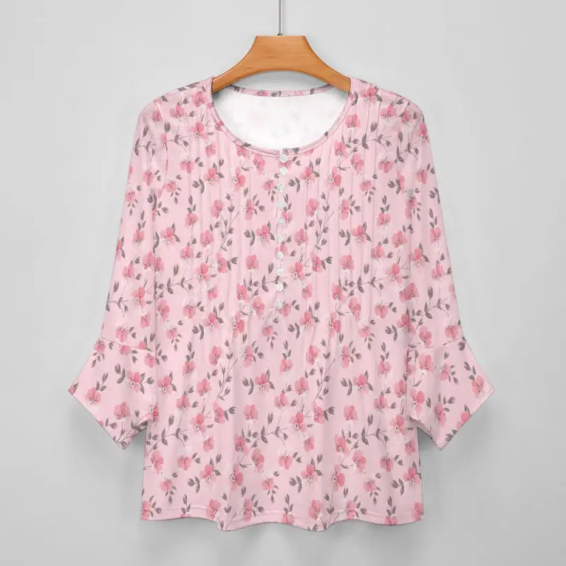 Women’s Pink Floral Print Bohemian Top on a wooden hanger, showcasing three-quarter sleeves